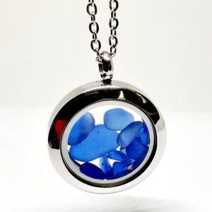 Stainless steel locket filled with cobalt blue sea glass